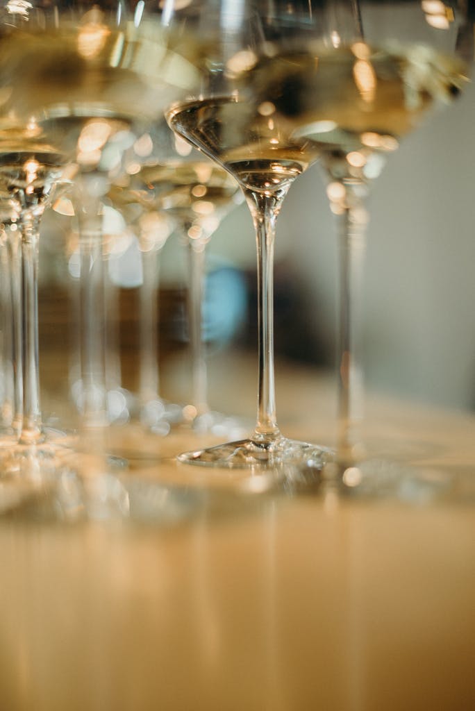 A close-up of elegantly arranged white wine glasses creating a sophisticated atmosphere.